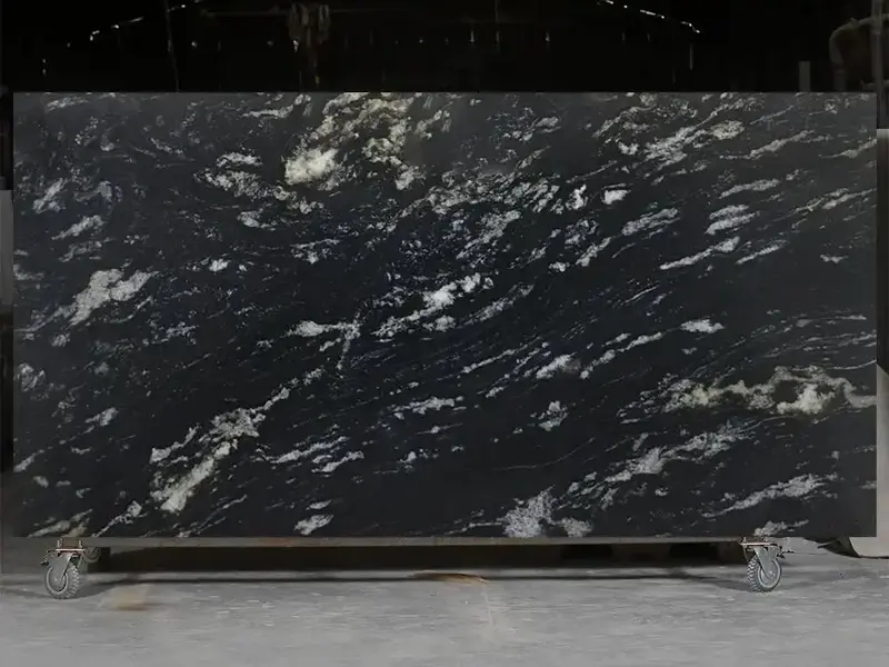 Polished slab of Titanium Black Granite featuring dramatic white and silver veining on a deep black background